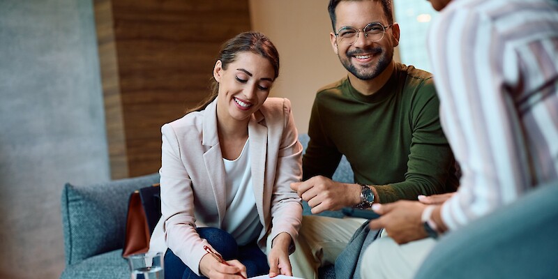 Happy couple signing paperwork